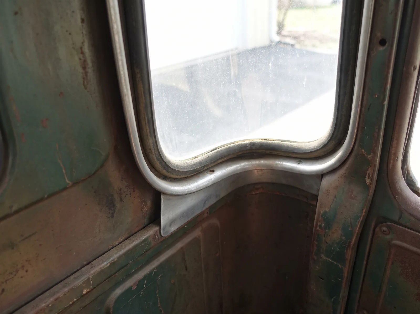 Factory-pressed Nu-Vue corner window opening seen from inside the cab of an Advance Design pickup