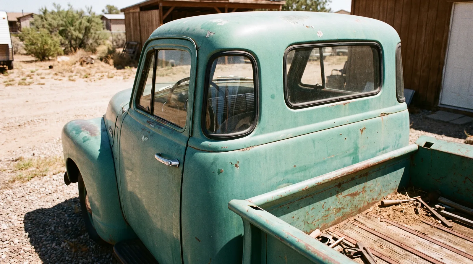 Rear three-quarter view of a 1951 Chevrolet Advance Design pickup showing the curved Nu-Vue corner window in the cab