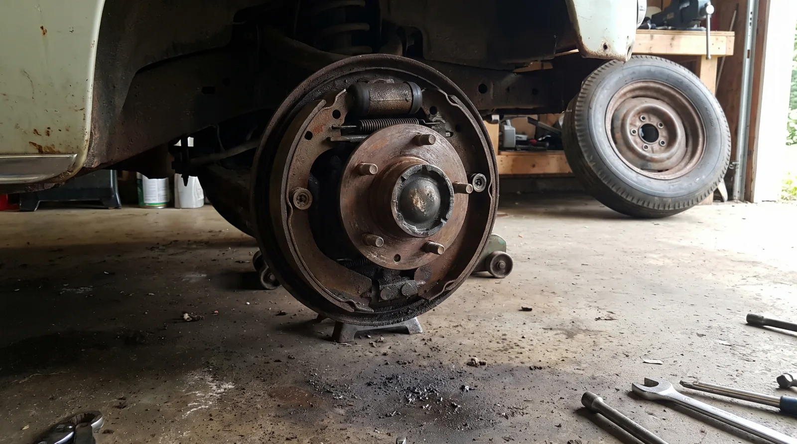 Brake drum and backing plate removed from an early 1950s Chevrolet showing shoes and wheel cylinder