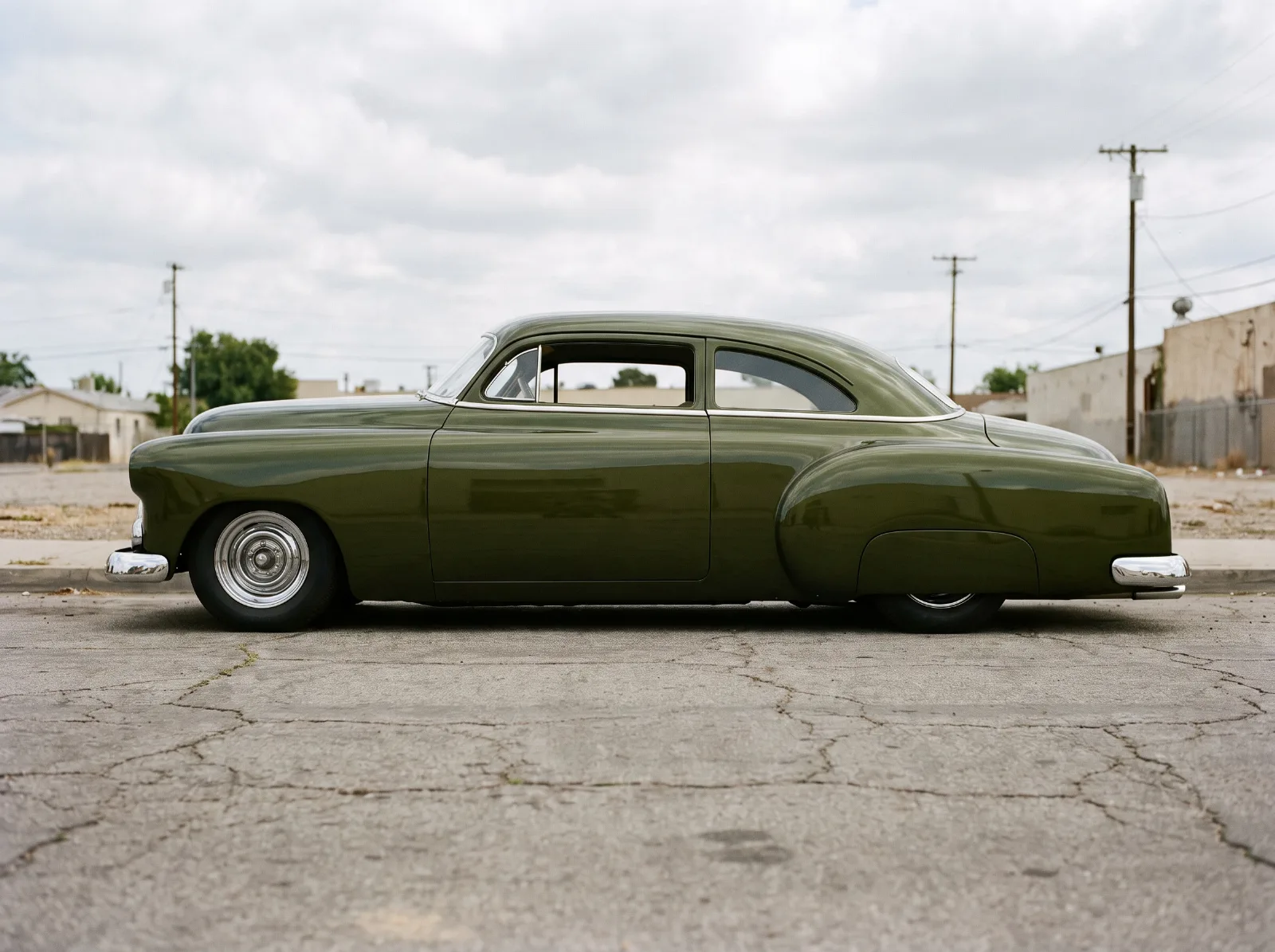 Chopped and lowered early 1950s Chevrolet in profile, badges and handles removed
