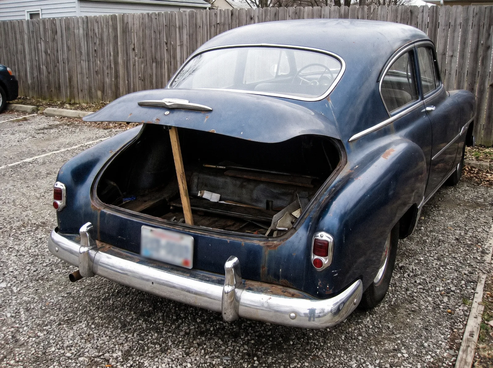 The small low luggage opening at the bottom of a Fleetline fastback tail, with the lid propped open