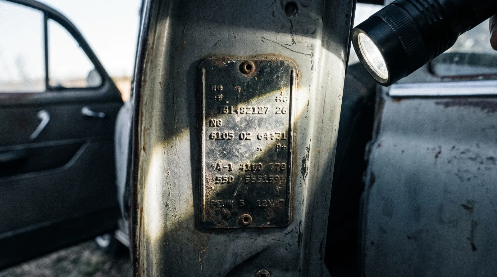 Serial number plate on the door pillar of an early 1950s Chevrolet, door open
