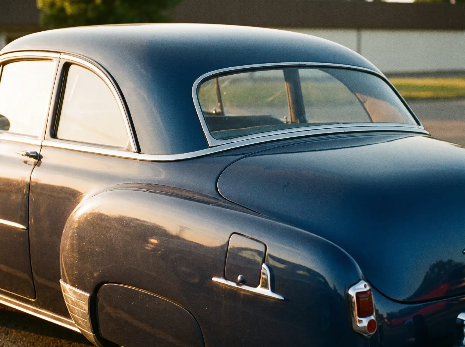 Rear quarter and roofline detail of a 1951 Chevrolet Sport Coupe with chrome window surrounds