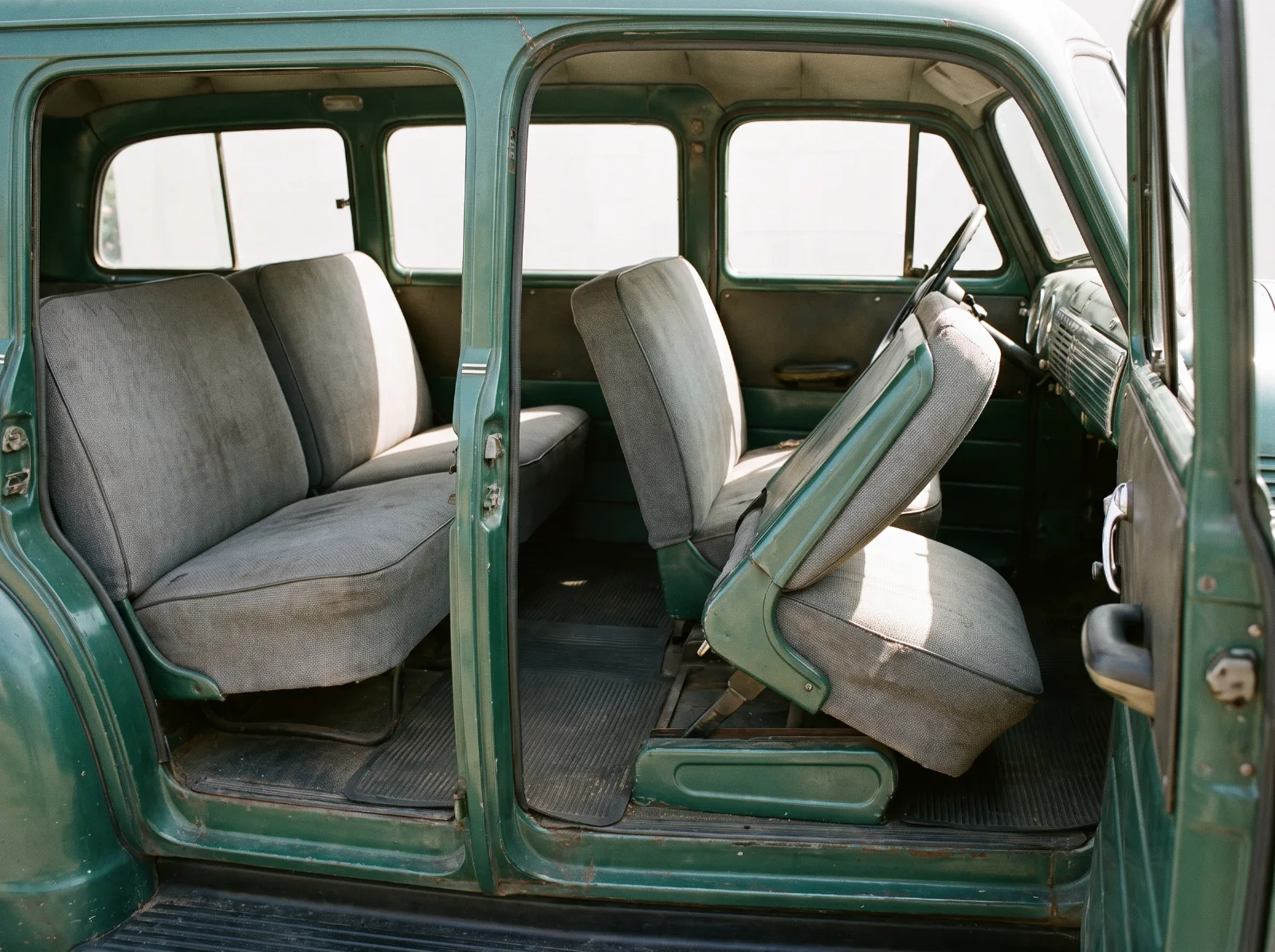 Carryall Suburban interior with the right-hand front seat slid forward to reach the rear benches