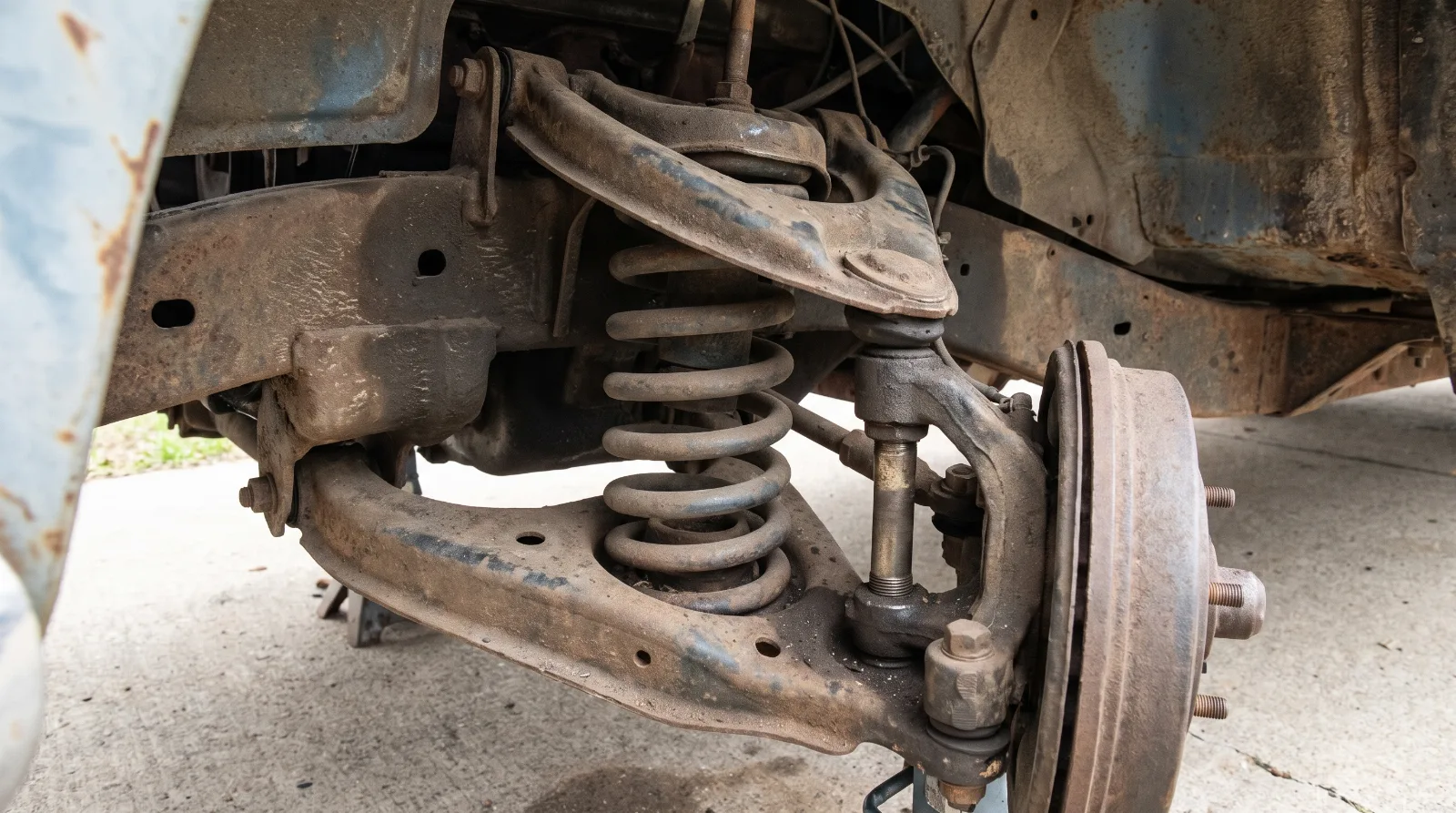 Front coil spring, control arms and king pin assembly on an early 1950s Chevrolet