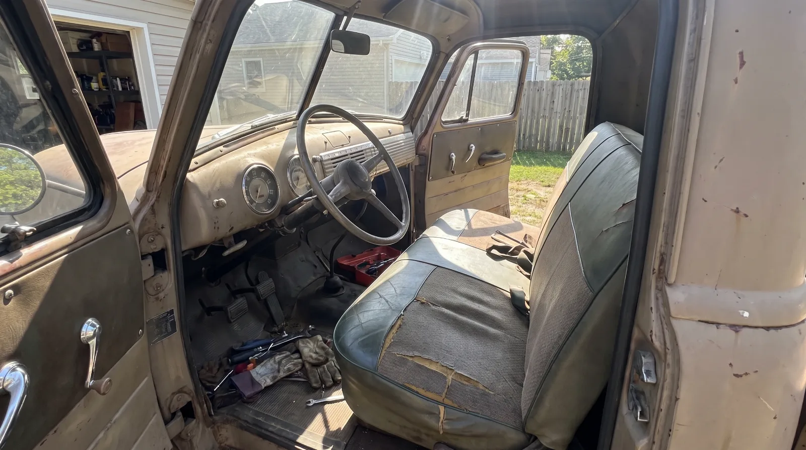 Bench seat and painted dashboard inside an Advance Design Chevrolet truck cab
