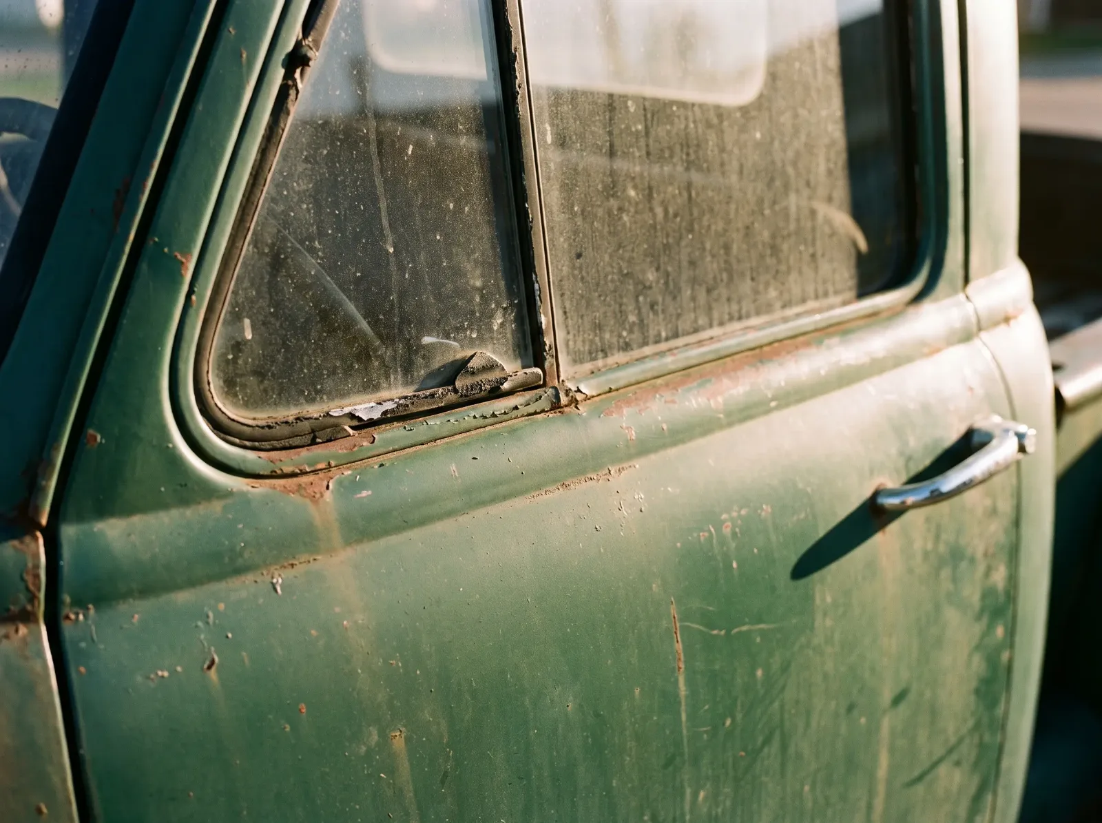 Vent window and turndown exterior door handle on the door of an early 1950s Chevrolet pickup