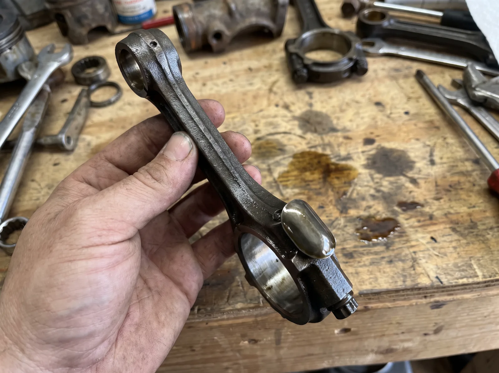 Connecting rod from a Chevrolet six showing the dipper on the bottom of the cap